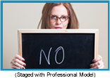 Woman holding halkboard with the word "NO" written on it (Staged with a Professional Model).