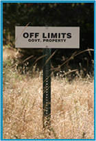 Sign in the middle of a field saying "OFF LIMITS"