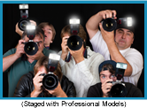 Tight group of photographers with using flash cameras. (Staged with professional models).