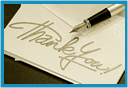 A thank you note with a pen resting on it.