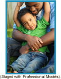 African-American father hugging son. (Staged with professional models).